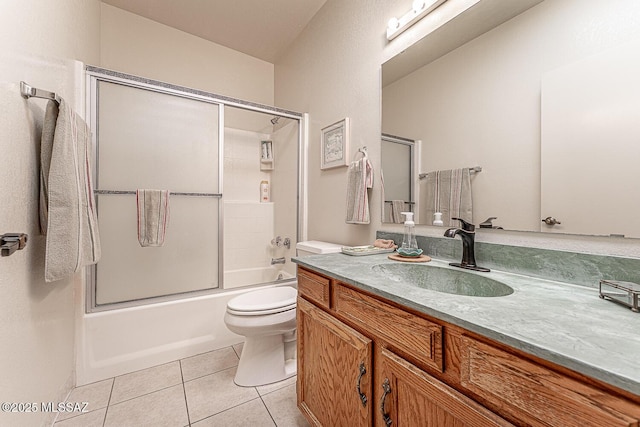 full bathroom featuring toilet, vanity, tile patterned floors, and combined bath / shower with glass door