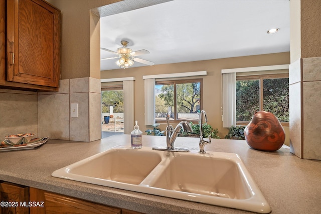 kitchen with tasteful backsplash, sink, and ceiling fan