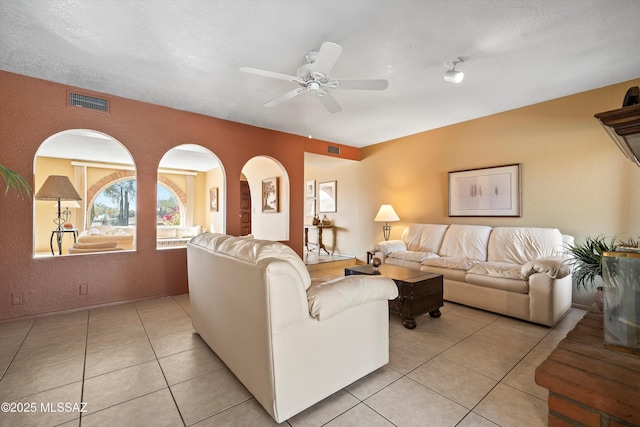 tiled living room featuring ceiling fan