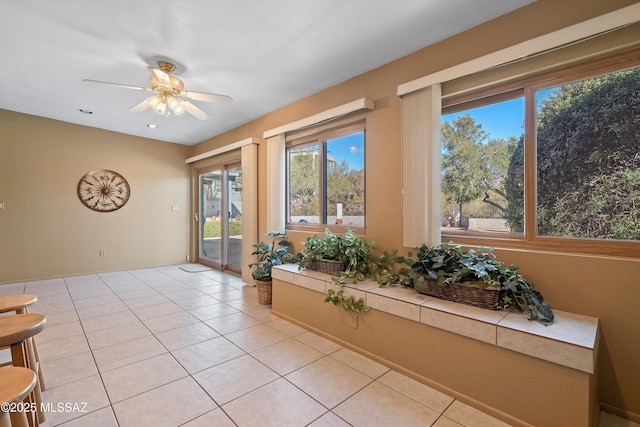 sunroom with ceiling fan