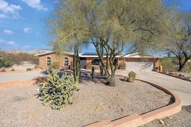 ranch-style house with a mountain view and a garage