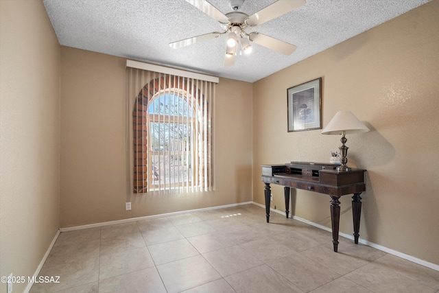 interior space with ceiling fan, a textured ceiling, and light tile patterned floors