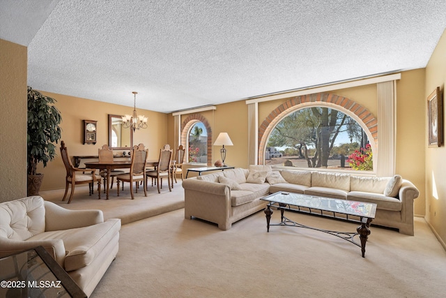 living room with light colored carpet, a notable chandelier, and a textured ceiling