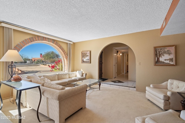 living room featuring light colored carpet and a textured ceiling