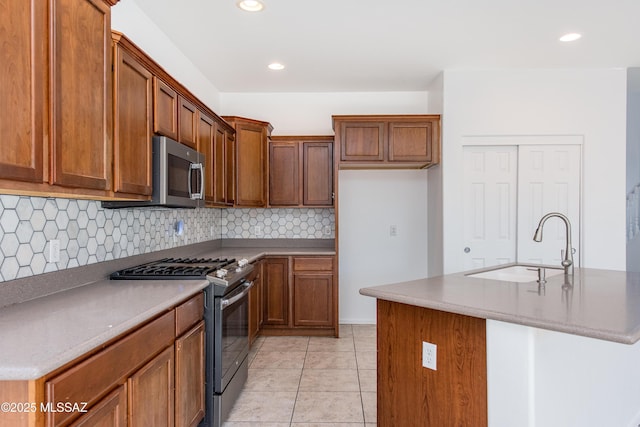 kitchen with brown cabinets, stainless steel appliances, and a sink