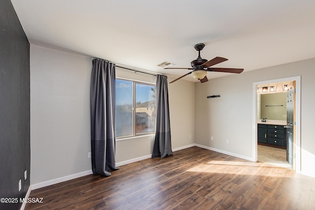 unfurnished bedroom featuring ceiling fan, connected bathroom, and dark hardwood / wood-style floors