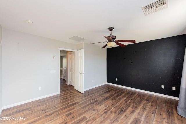 unfurnished room with ceiling fan and dark hardwood / wood-style floors