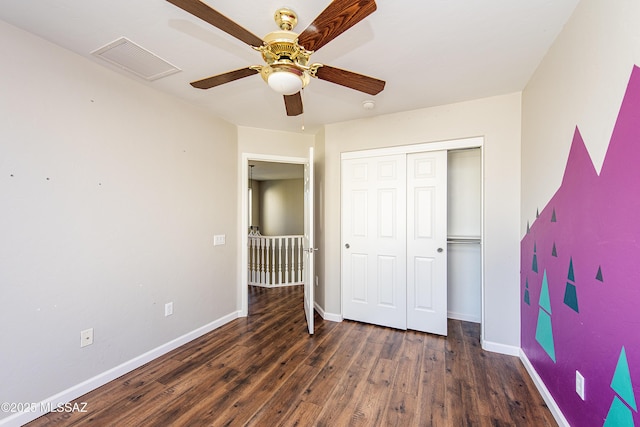 unfurnished bedroom with ceiling fan, a closet, and dark hardwood / wood-style flooring