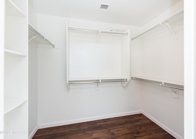 spacious closet with dark wood finished floors and visible vents