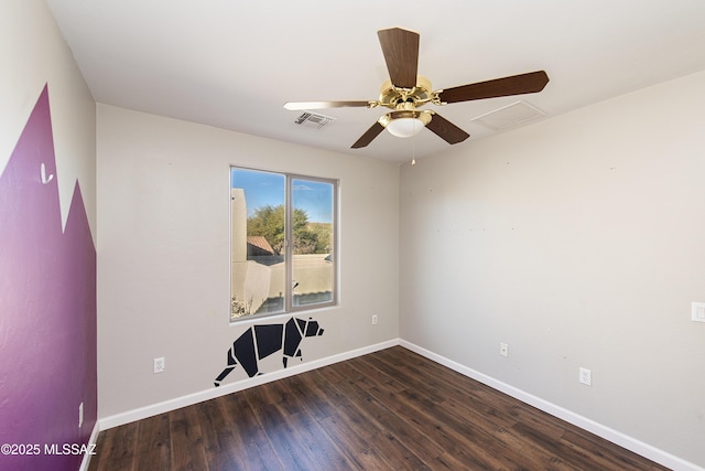 empty room featuring ceiling fan and dark hardwood / wood-style flooring