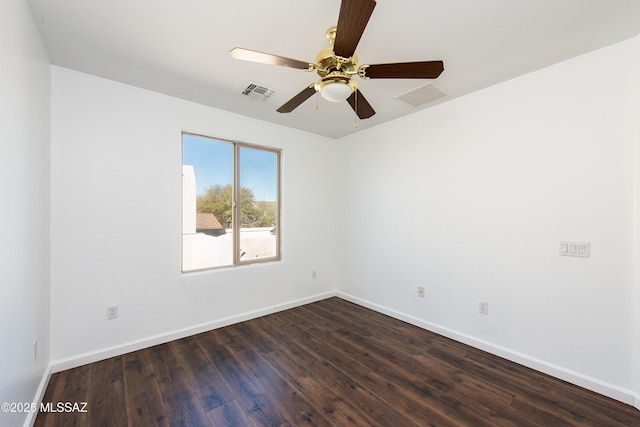 empty room with visible vents, baseboards, dark wood finished floors, and a ceiling fan