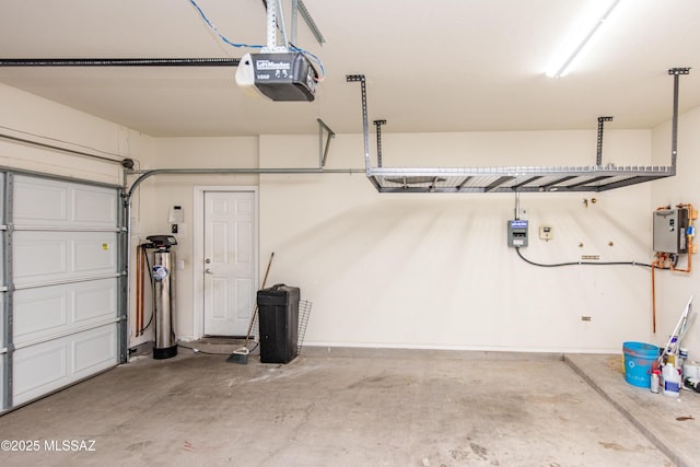 garage with water heater and a garage door opener