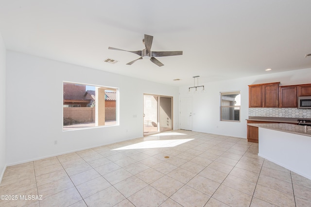 unfurnished living room with visible vents, baseboards, light tile patterned floors, recessed lighting, and a ceiling fan