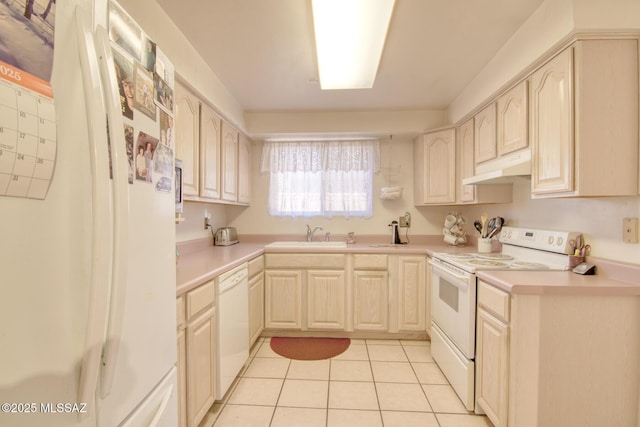 kitchen featuring white appliances, light tile patterned floors, and sink