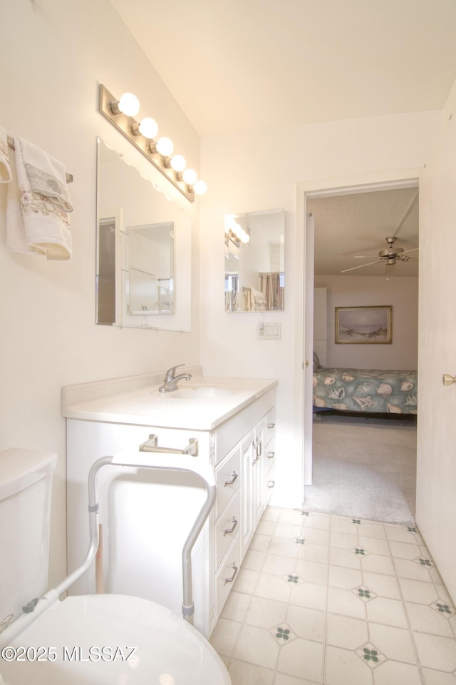 bathroom with ceiling fan, vanity, and toilet