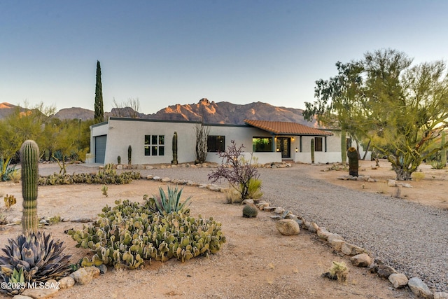 view of front facade with a mountain view and a garage