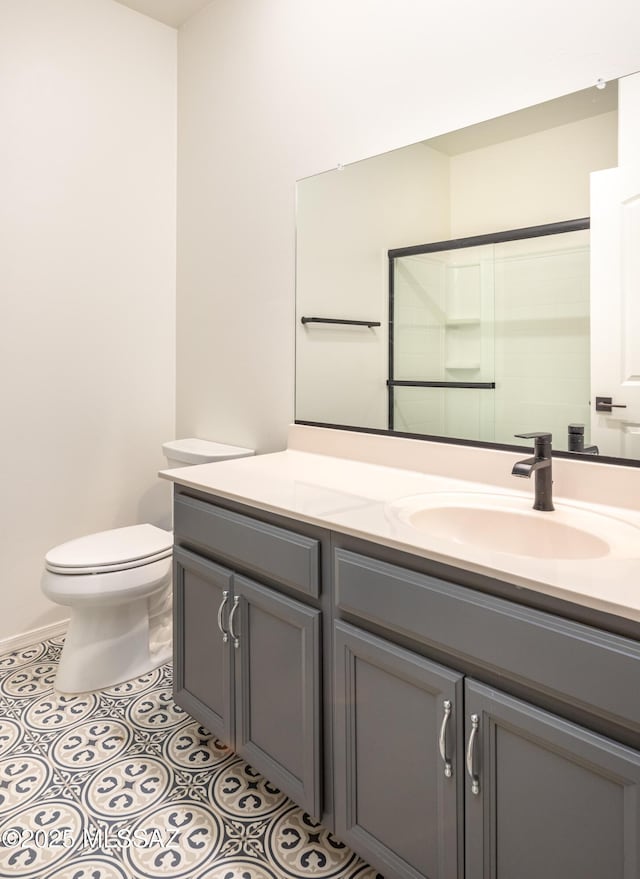 bathroom featuring vanity, an enclosed shower, tile patterned floors, and toilet