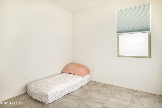 bedroom featuring light tile patterned flooring