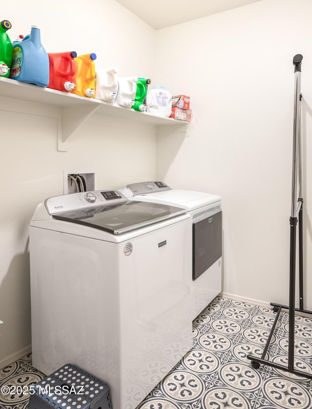 washroom with separate washer and dryer and light tile patterned floors