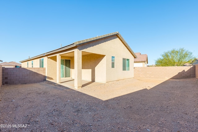 8757 E Pebble Stone Ln, Tucson, AZ 85730 - back of house with a patio area, a tiled roof, a fenced backyard, and stucco siding