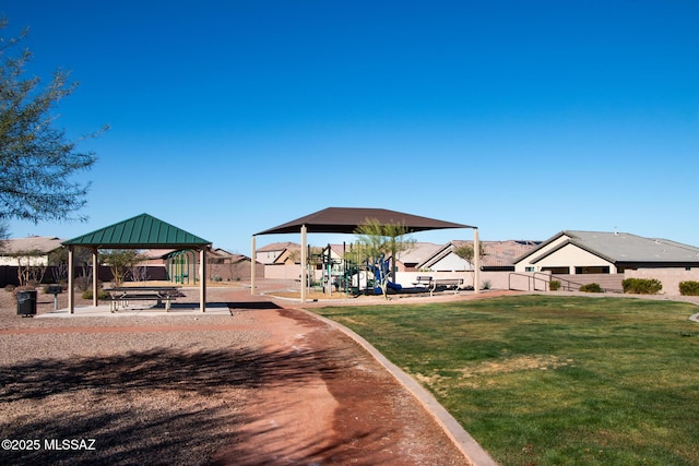 view of property's community with a playground, a gazebo, and a lawn