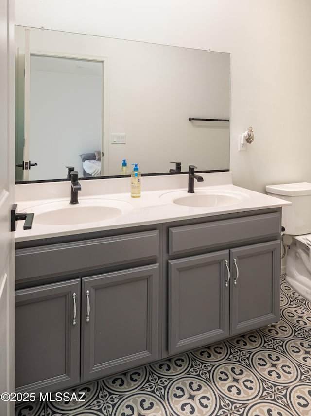 bathroom featuring vanity, toilet, and tile patterned flooring