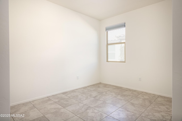 unfurnished room with light tile patterned flooring