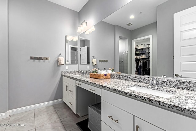 bathroom with tile patterned flooring and vanity