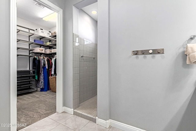 bathroom featuring tile patterned floors and tiled shower