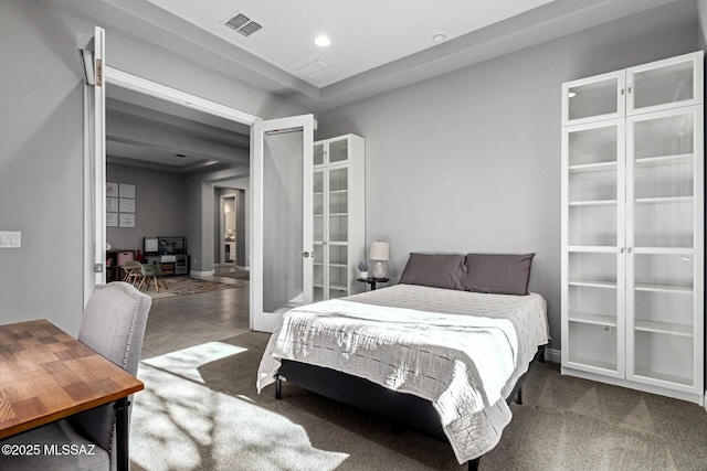 carpeted bedroom with french doors