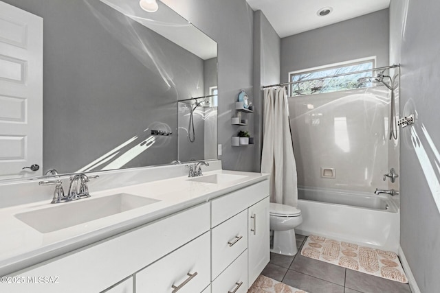 full bathroom with shower / tub combo with curtain, vanity, tile patterned floors, and toilet