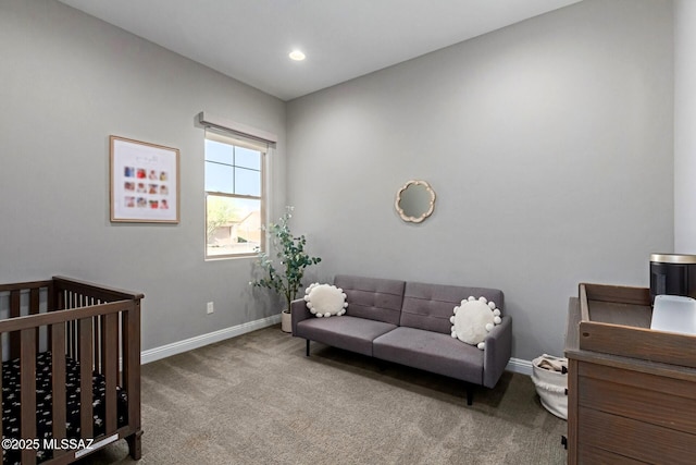 bedroom with a nursery area and carpet floors