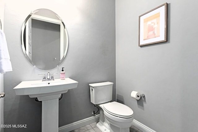 bathroom with tile patterned floors, toilet, and sink