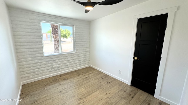 unfurnished room featuring ceiling fan and light hardwood / wood-style floors