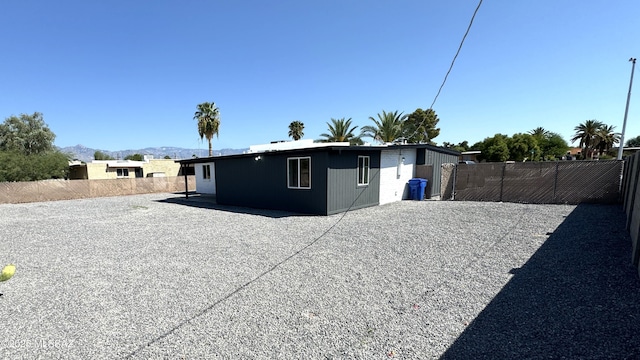 rear view of house with a mountain view and a patio area