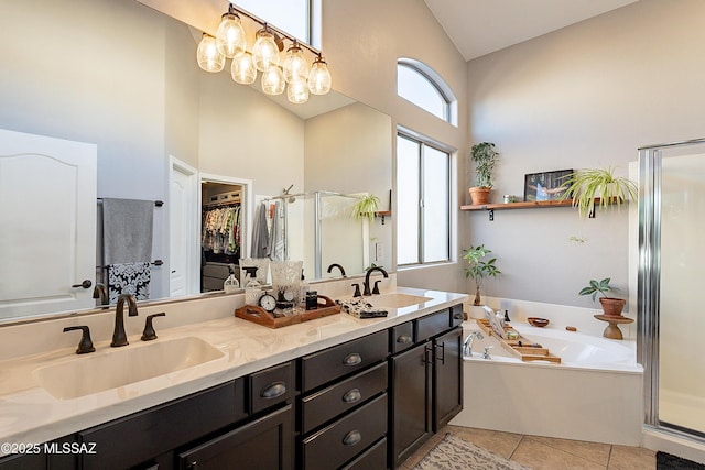 bathroom with vanity, plenty of natural light, shower with separate bathtub, and tile patterned floors