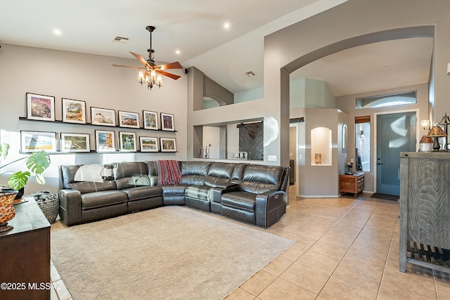 tiled living room with high vaulted ceiling and ceiling fan