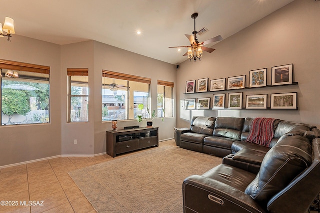 tiled living room with ceiling fan and vaulted ceiling