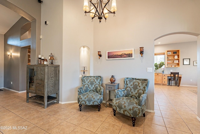 sitting room with light tile patterned floors and a towering ceiling