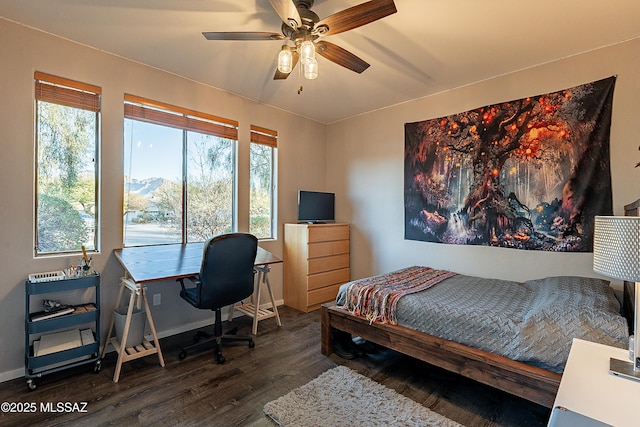 bedroom with multiple windows, dark wood-type flooring, and ceiling fan