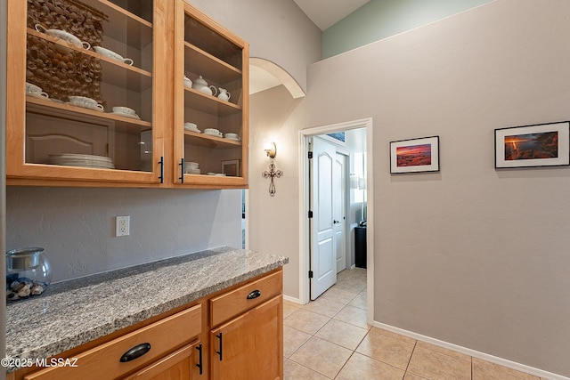 kitchen with stone countertops and light tile patterned floors