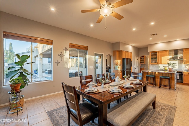 tiled dining room featuring ceiling fan