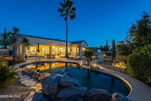 view of pool at dusk