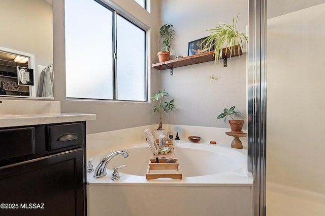 bathroom with vanity, plenty of natural light, and independent shower and bath