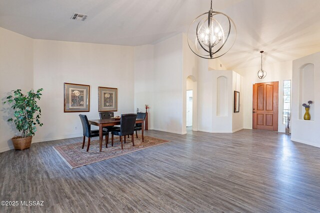 entryway with a high ceiling, a chandelier, and hardwood / wood-style floors