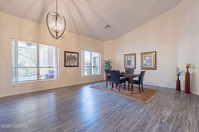 dining space with dark hardwood / wood-style flooring and a notable chandelier