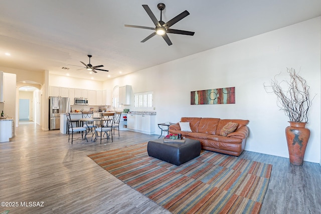 living room with ceiling fan and hardwood / wood-style flooring