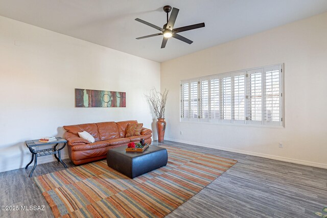 living room featuring ceiling fan and dark hardwood / wood-style floors