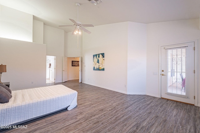 bedroom with ceiling fan, dark hardwood / wood-style floors, and access to outside