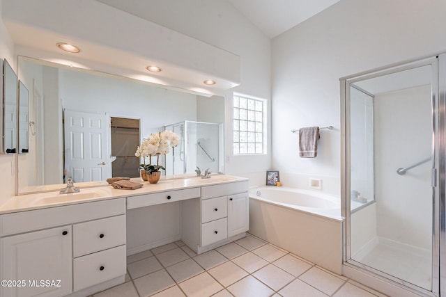 bathroom with shower with separate bathtub, lofted ceiling, tile patterned floors, and vanity